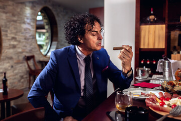 Businessman enjoying his expensive cigar