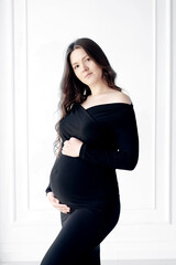 beautiful young pregnant woman in dark black dress