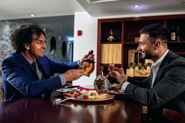Businesspeople enjoying a hard drink
