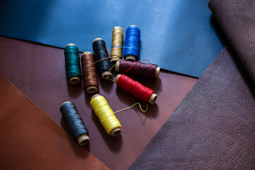 Colorful group of wax thread leather working on leather background