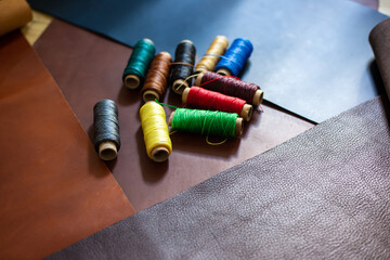 Colorful group of wax thread leather working on leather background