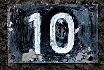Number 10, ten, vintage plate with white digits.