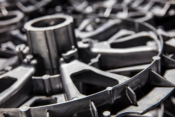 Close-up view of stainless steel hardware components on black background