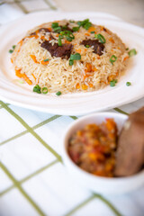 .pilaf and salad, black bread on the table