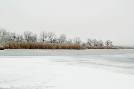 Picture of bright white winter landscape with frozen lake