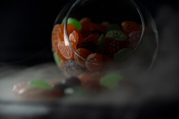 Multicolored caramel in a glass vase