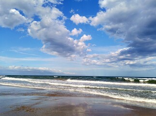 Clouds waves and reflection of the sea