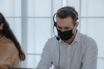 Businessman having chatting with mask at workplace office with laptop