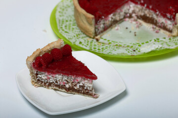 Levington sliced cake with raspberry jelly, chocolate and coconut. Garnished with raspberries.