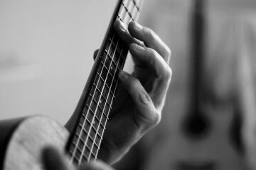 Close up of hands playing the ukulele