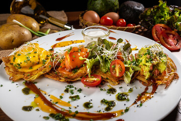 pancakes from grated potatoes fried in a pan. Served with sour cream, onion, egg, bacon
