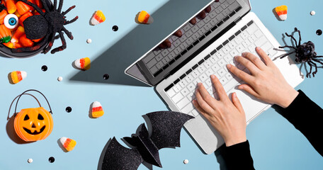 Halloween decorations with person using a laptop computer - overhead view flat lay