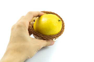 Basket with harvesting lemon in man's hand on white isolated background