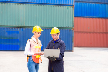 Foreman control Industrial Container Cargo freight ship. Foreman using laptop computer in the port of loading goods. Looking forward.