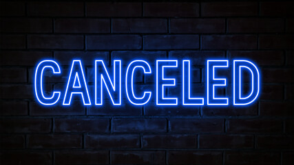Canceled - blue neon light word on brick wall background