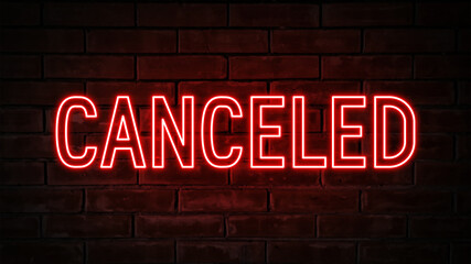 Obraz premium Canceled - red neon light word on brick wall background