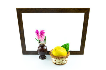 Composition of lemon and decorative vase on wooden frame on white isolated background
