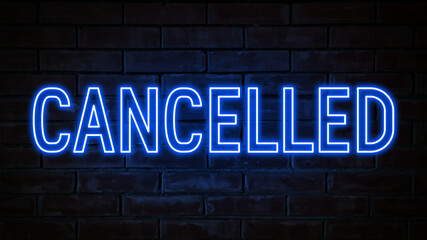 Cancelled - blue neon light word on brick wall background