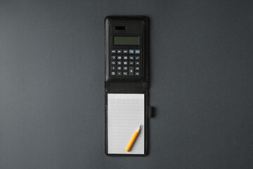Notebook with calculator and pencil