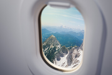 Naklejka premium View from airplane window on Alps mountains.