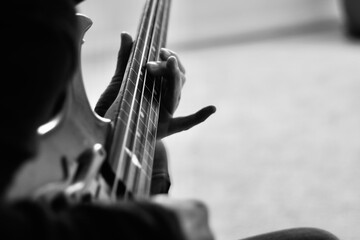 a person playing electric bass guitar