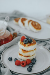 Tasty curd cheesecakes with berries on a plate. High quality photo
