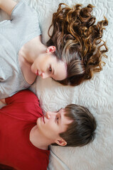 Young couple in bed top view.