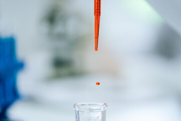 close up. background image of a drop of red liquid in a laboratory pipette.