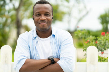 Close up head shot handsome african american model smile  wears casual cloths outdoors at home.