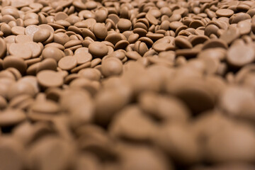 Field of many brown milk chocolat pellets