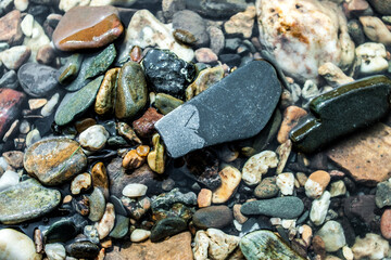 stones on the beach in the water
