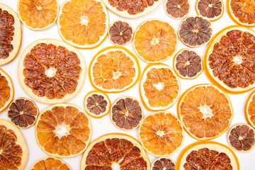 Dried slices of various citrus fruits on white background