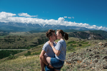 Fototapeta na wymiar Loving couple together on Altai mountain looking at a view