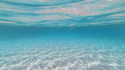 Underwater photo of tropical exotic sandy sea bed with turquoise sea