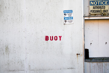 Buoy Stencil on Building at Dock