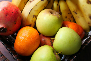 top view of apple, banana and orange in a bowl on table 