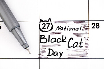 Reminder National Black Cat Day in calendar with pen