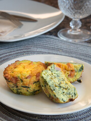 Breakfast Egg Muffins loaded with fluffy eggs, potatoe, spinach, melted cheese and crisp bites of Canadian bacon.