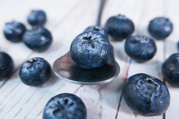 Close up of fresh blue berry fruits on spoon 