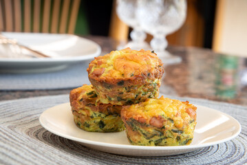 Breakfast Egg Muffins loaded with fluffy eggs, potatoe, spinach, melted cheese and crisp bites of...