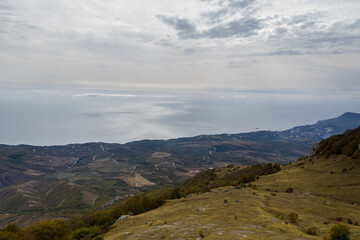 Fototapeta premium a panoramic view of the beautiful mountains with unusual ledges and rocks against the background of the sky and the valley filmed from a drone