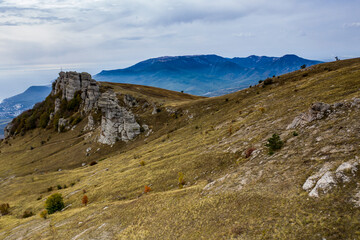 beautiful mountains with unusual ledges and tales against the background of the sky and the valley
