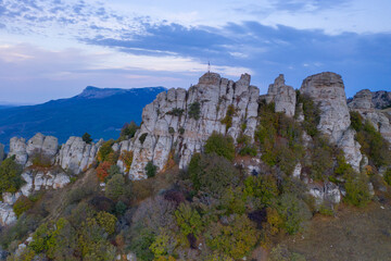 beautiful mountains with unusual ledges and tales against the background of the sky and the valley