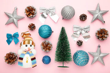 Christmas composition made of christmas decoration on pink background. Flat lay