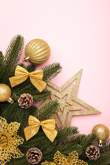 Christmas background with gold decorations on pink background. Vertical foto