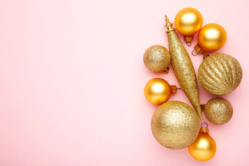 Golden christmas ball on pink background. studio shot