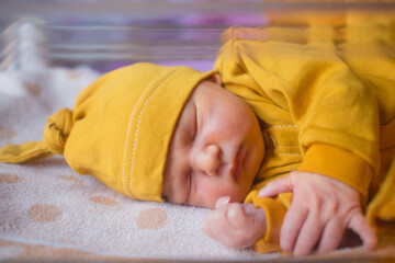 Newborn male baby sleeping calmly inside