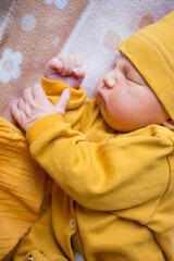 Newborn male baby sleeping calmly inside