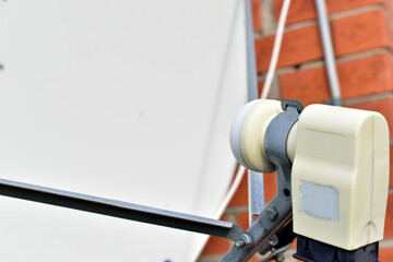 White satellite dish with receiver and transmitter