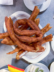 TOP VIEW OF A PLATE OF CHURROS READY TO EAT